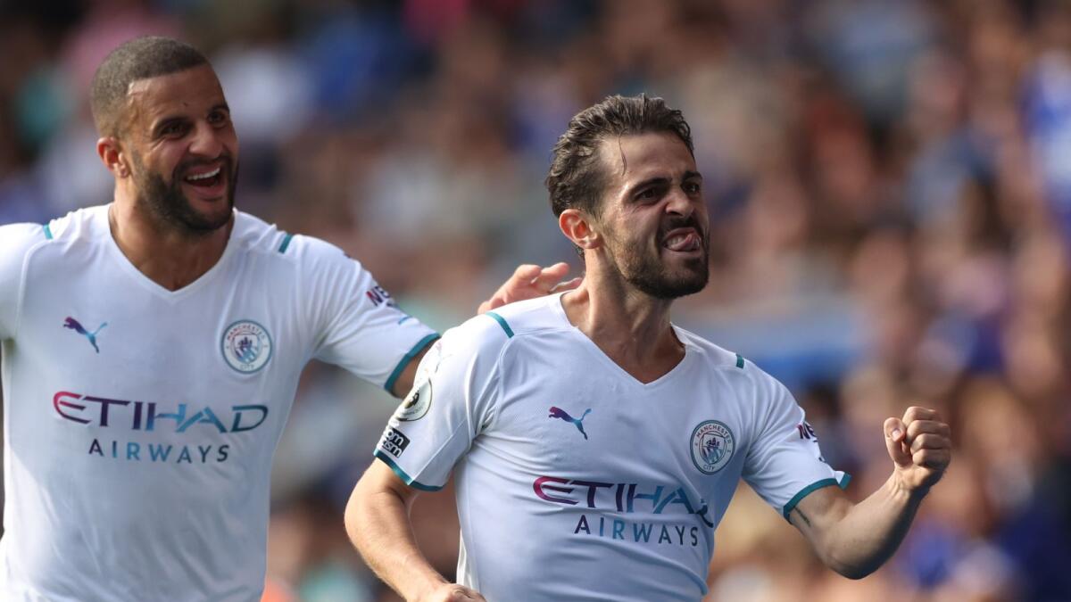 Manchester City's Bernardo Silva celebrates his goal with Kyle Walker against Leicester City. — Reuters