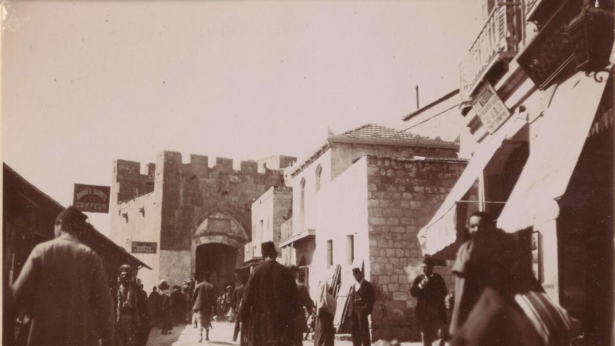 A street scene beside Jaffa Gate, including a photography studio and barbers, in Jerusalem, Palestine (1898)