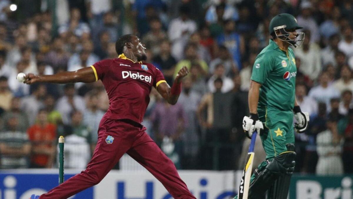 West Indies Carlos Brathwaite (L) bowls during the T20I match between Pakistan and West Indies at the during the T20I match between Pakistan and West Indies at the Sheikh Zayed Cricket Stadium  in Abu Dhabi 