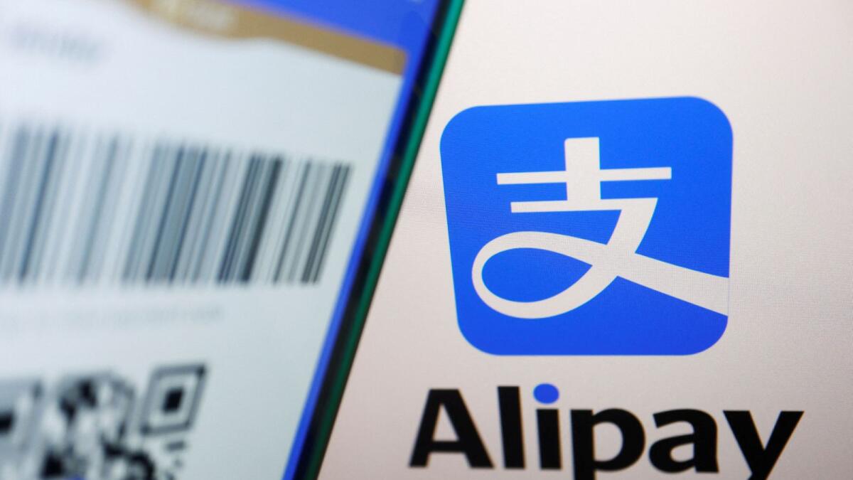 The Alipay logo is displayed next to a QR payment code on the app. — Reuters