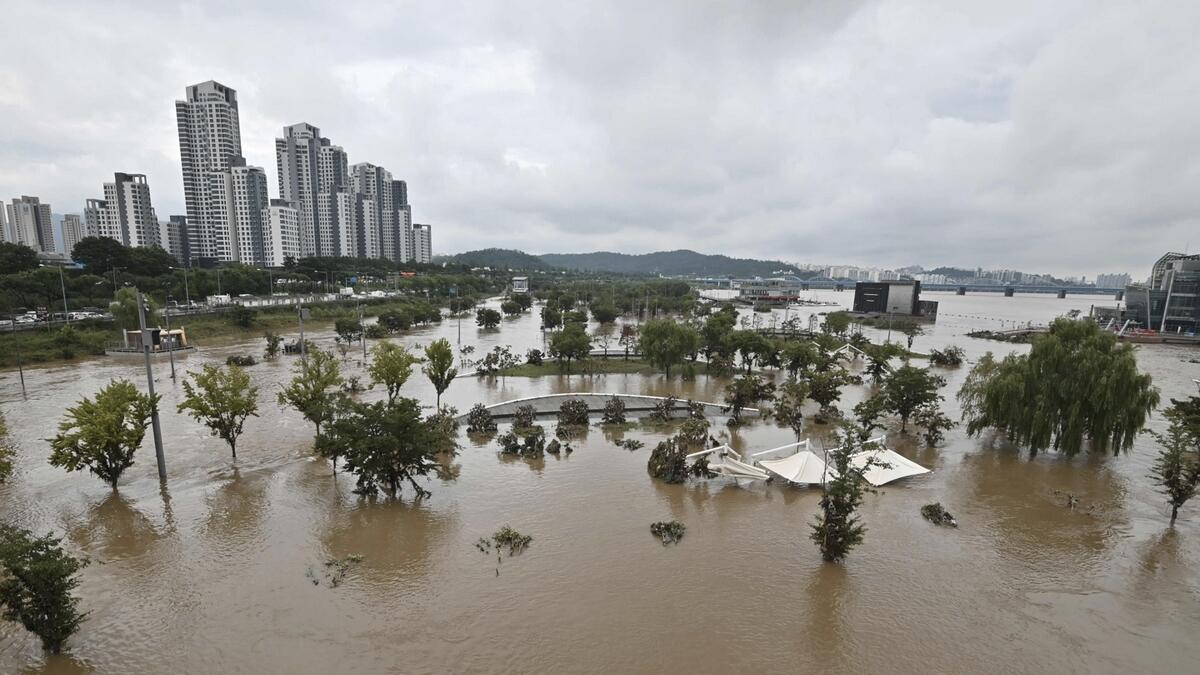 A park beside the Han river is flooded following heavy rainfall in Seoul. South Korea's monsoon season, which begun on June 24, tied the previous record of 49 days set in 2013, the Korea Meteorological Administration said, but will likely set a fresh record with more downpours expected until mid-August. Photo: AFP