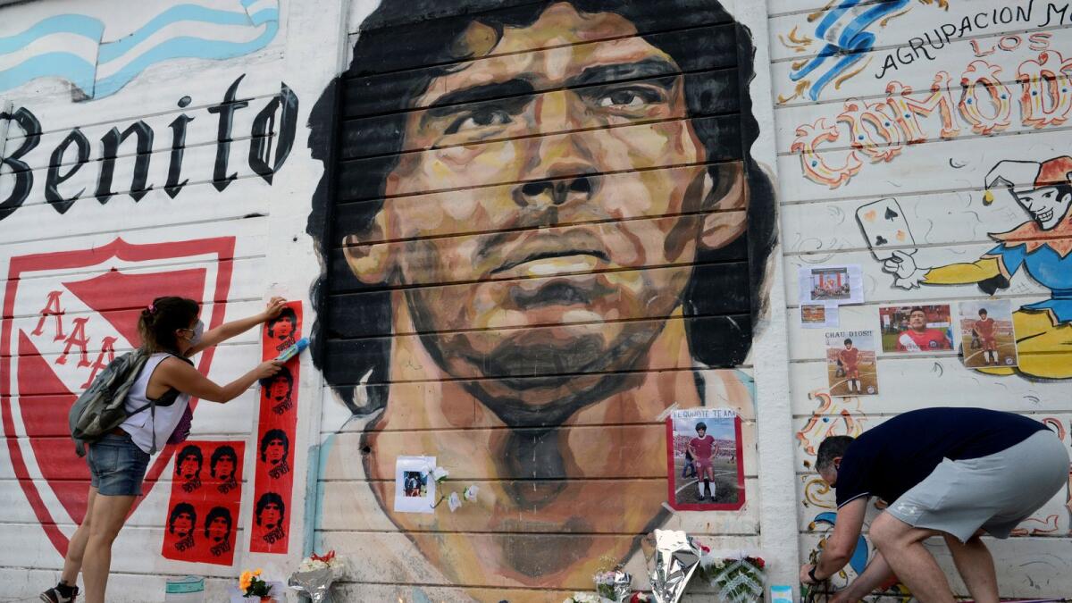 People gather to mourn the death of soccer legend Diego Armando Maradona, outside the Diego Amrando Maradona stadium, in Buenos Aires, Argentina, November 25, 2020.
