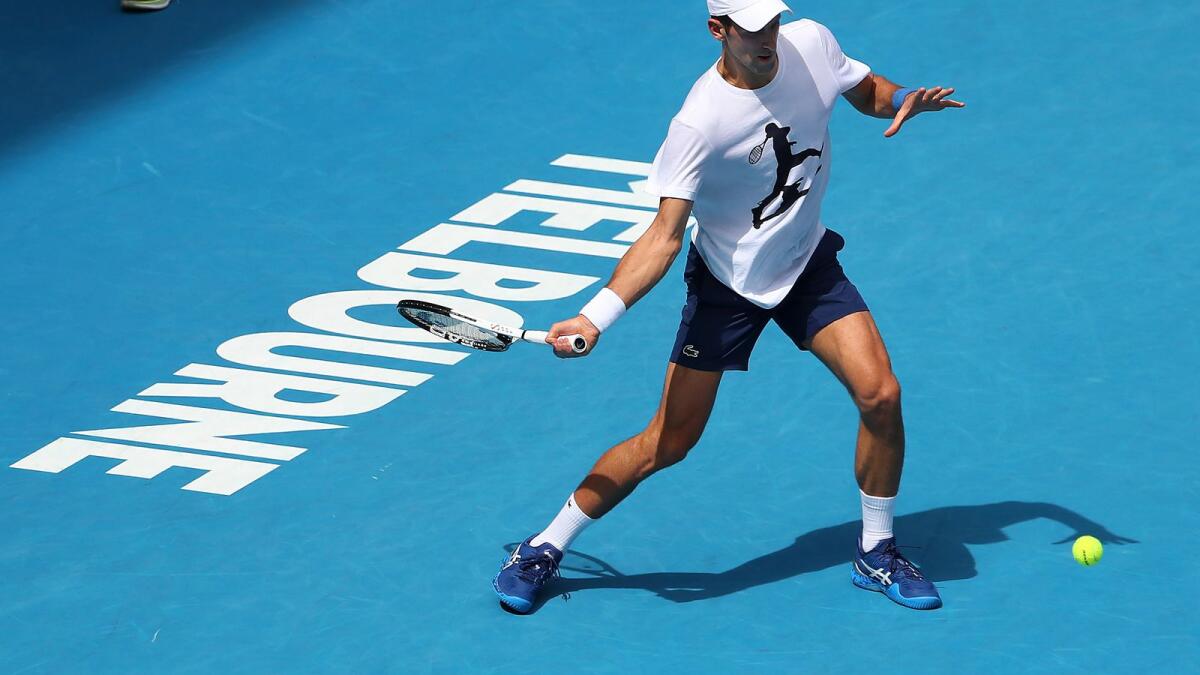 Novak Djokovic plays a forehand return during a practice session at the Rod Laver Arena on Tuesday. (AP)