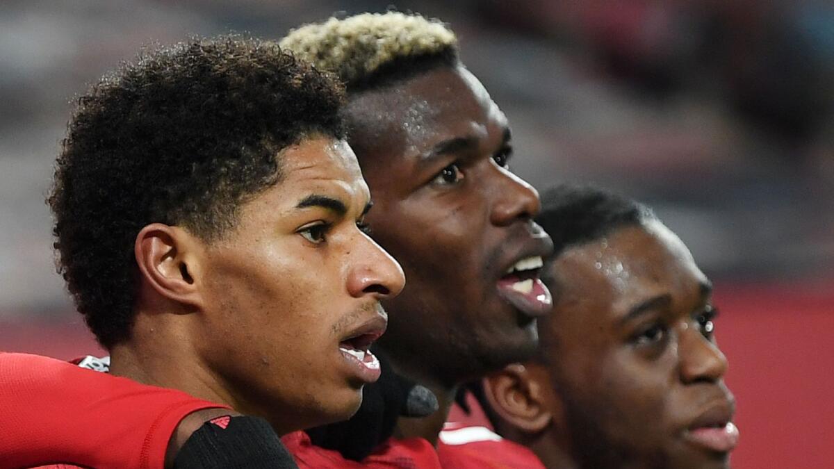 Manchester United striker Marcus Rashford (left) celebrates after scoring the goal with Paul Pogba and Aaron Wan-Bissaka. (AFP)