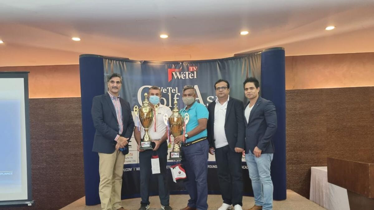 Namir Al Nami (left centre) and Dr Ahmad Jaffar (right centre) with their trophies along with organisers and sponsors from WeTel TV and Orient Travel. — Supplied photo