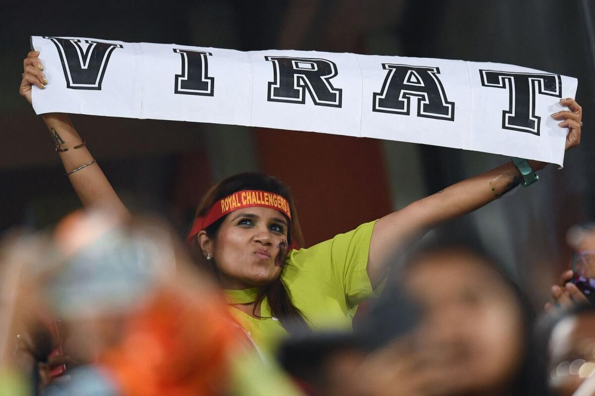 A Virat Kohli fan holds a banner during the match on Thursday. — AFP