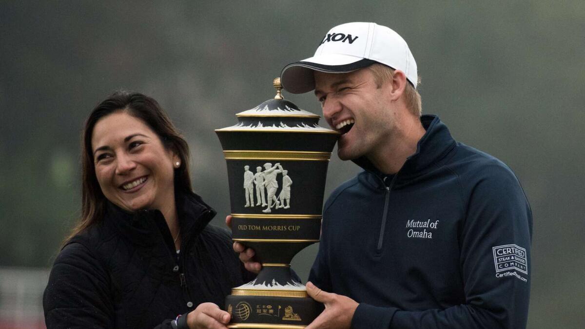 Russell Knox of Scotland and his wife Andrea pose with his trophy after winning the WGC tournament in Shanghai. 