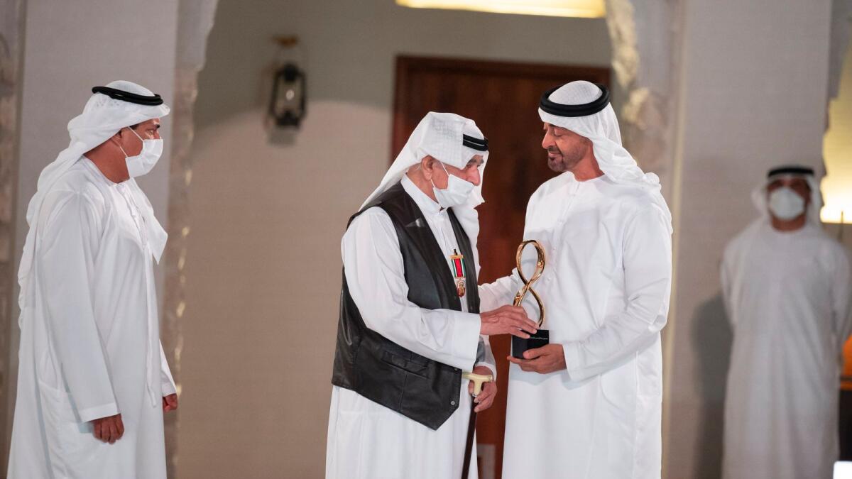 Sheikh Mohamed bin Zayed Al Nahyan  presents an award to Hussain Abdulrahman Khansaheb.