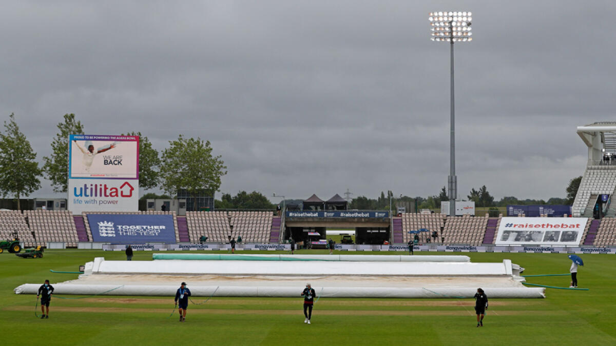 Groundstaff pull the covers on as rain delayed the start of play on the first day of the first Test between England and the West Indies at the Ageas Bowl in Southampton on Wednesday. - AFP