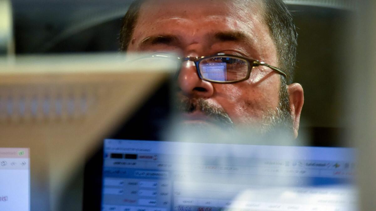 A broker monitors latest share prices at the Pakistan Stock Exchange in Karachi. — AFP file