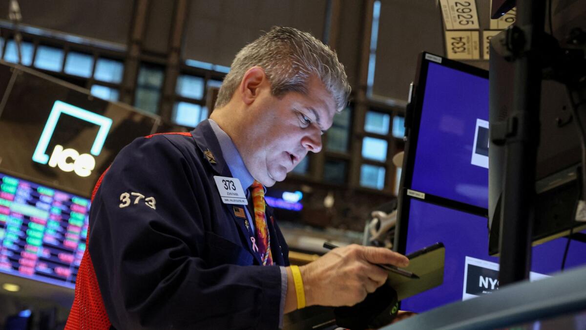 A trader works on the floor of the New York Stock Exchange on Friday.  - Reuters