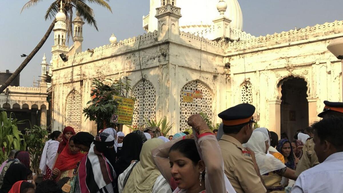 Indian women leave after visiting the inner sanctum of the Haji Ali Dargah in Mumbai.