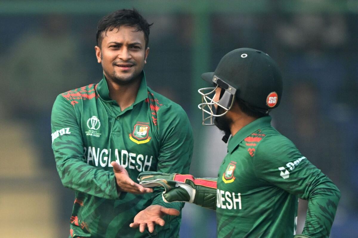 Bangladesh captain Shakib Al Hasan (left) celebrates with a teammate after taking the wicket of Sri Lanka's Sadeera Samarawickrama. — AFP