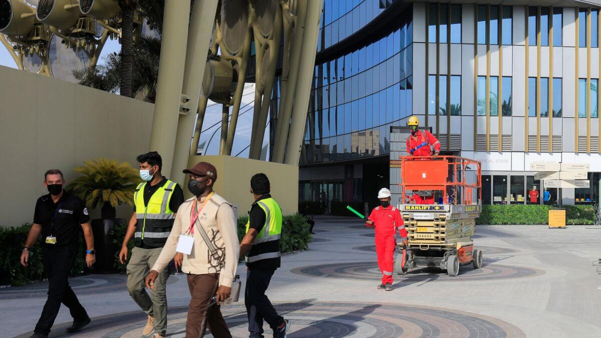Workers walk at the Expo 2020 site ahead of the opening ceremony on Thursday.