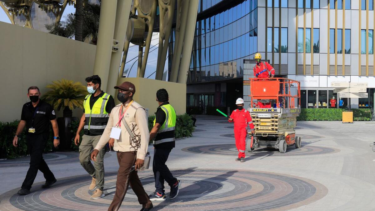 Workers walk at the Expo 2020 site ahead of the opening ceremony on Thursday.