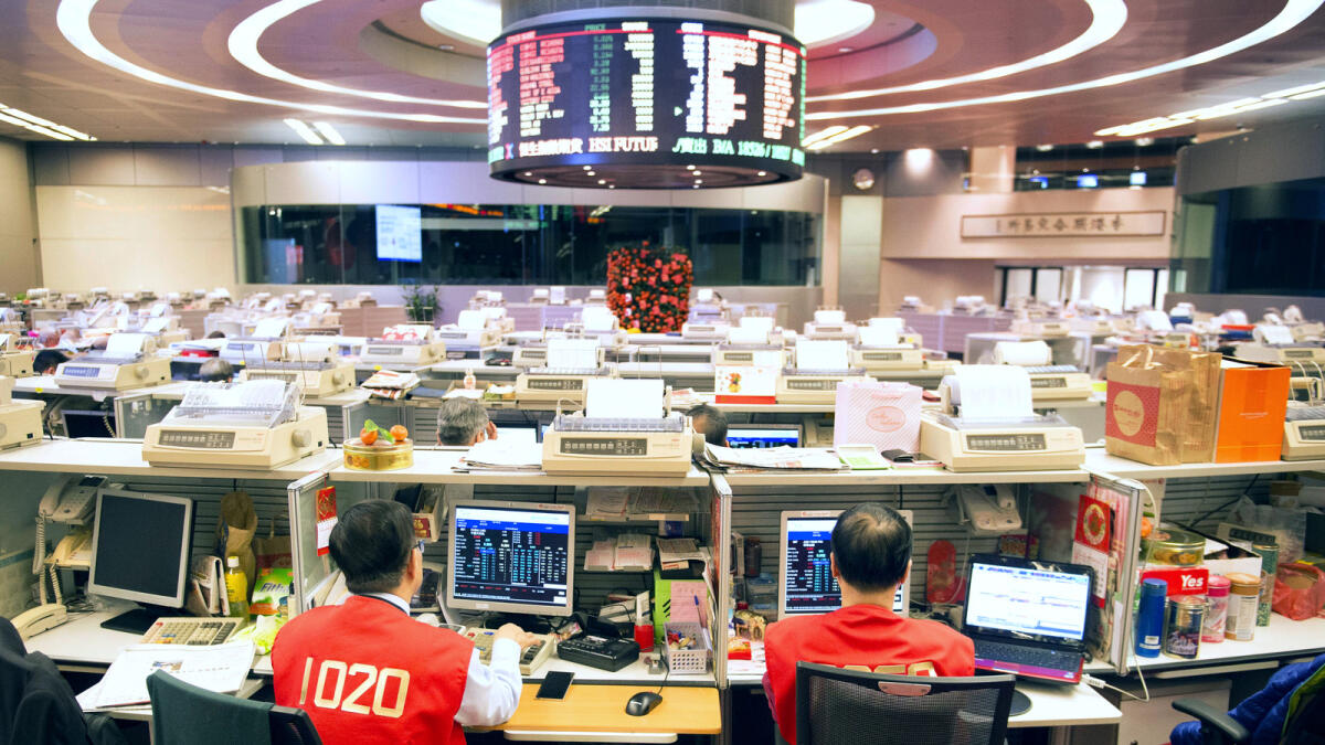 Traders work on the trading floor of the Hong Kong Stock Exchange during the first day of trading after lunar new year in Hong Kong, China, on Thursday. 