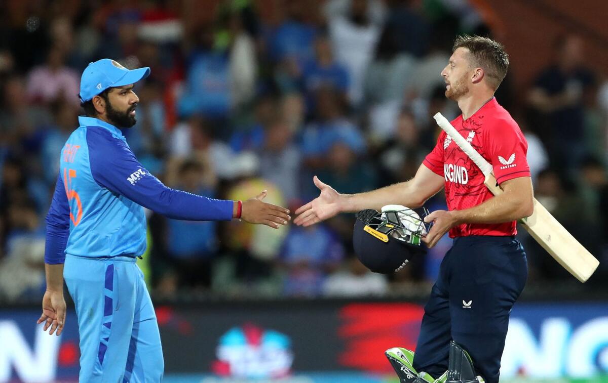Indian captain Rohit Sharma (left) shakes hands with England' skipper Jos Buttler after the game. — AFP