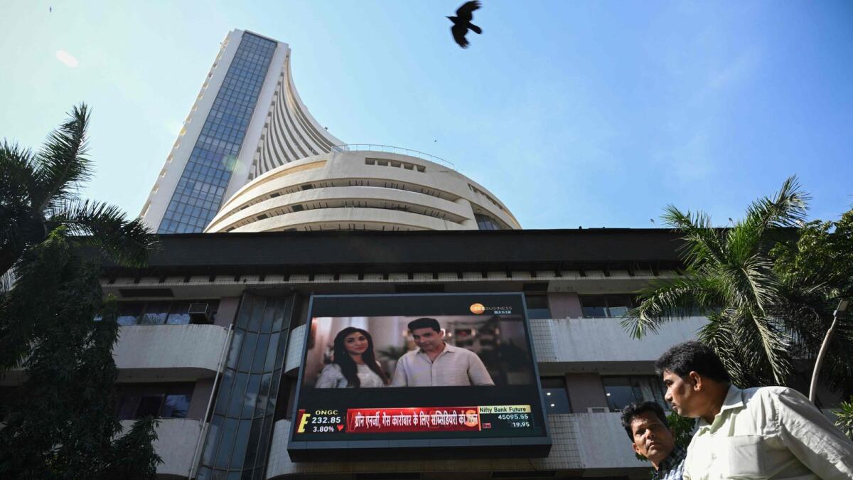 Pedestrians walk past the Bombay Stock Exchange (BSE) building in Mumbai on Tuesday. India's stock market has edged out Hong Kong to become the world's fourth-largest, a milestone that underscores growing global investor optimism about New Delhi's economic prospects. — AFP