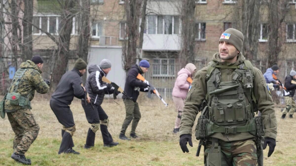 An instructor watches as civilians train with members of the Georgian Legion, a paramilitary unit formed mainly by ethnic Georgian volunteers to fight against the Russian aggression in Ukraine. — AP