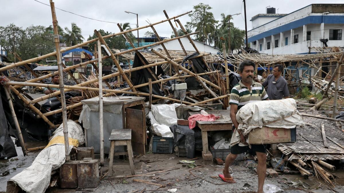 A man salvages his belongings from the rubble of a damaged shop after Cyclone Amphan made its landfall, in South 24 Parganas district in the eastern state of West Bengal, India, May 21, 2020. REUTERS/Rupak De Chowdhuri