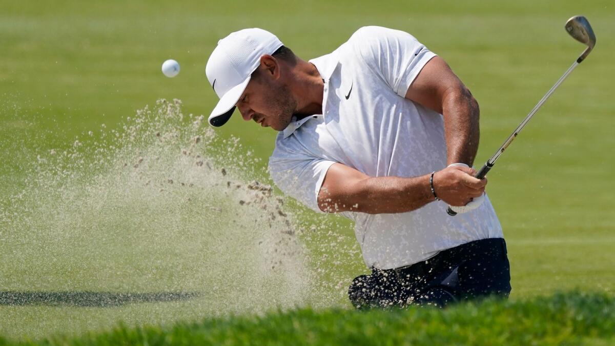 Brooks Koepka plays a shot from a bunker on the 15th hole during the first round of the US Open on Thursday. (AP)