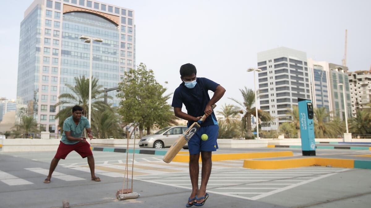 Residents plays cricket at the parking lot near Madinat Zayed shopping center in Abu Dhabi. Photo: Ryan Lim/Khaleej Times