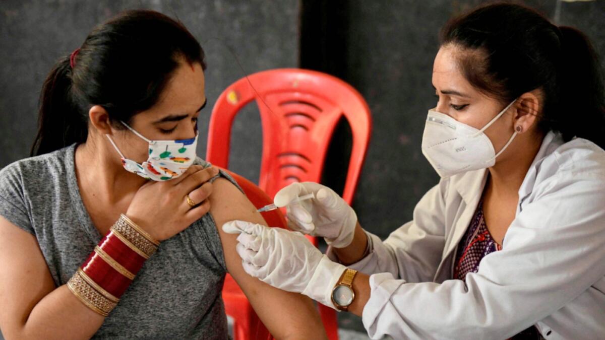 A woman receives Covid vaccine in India. — AP