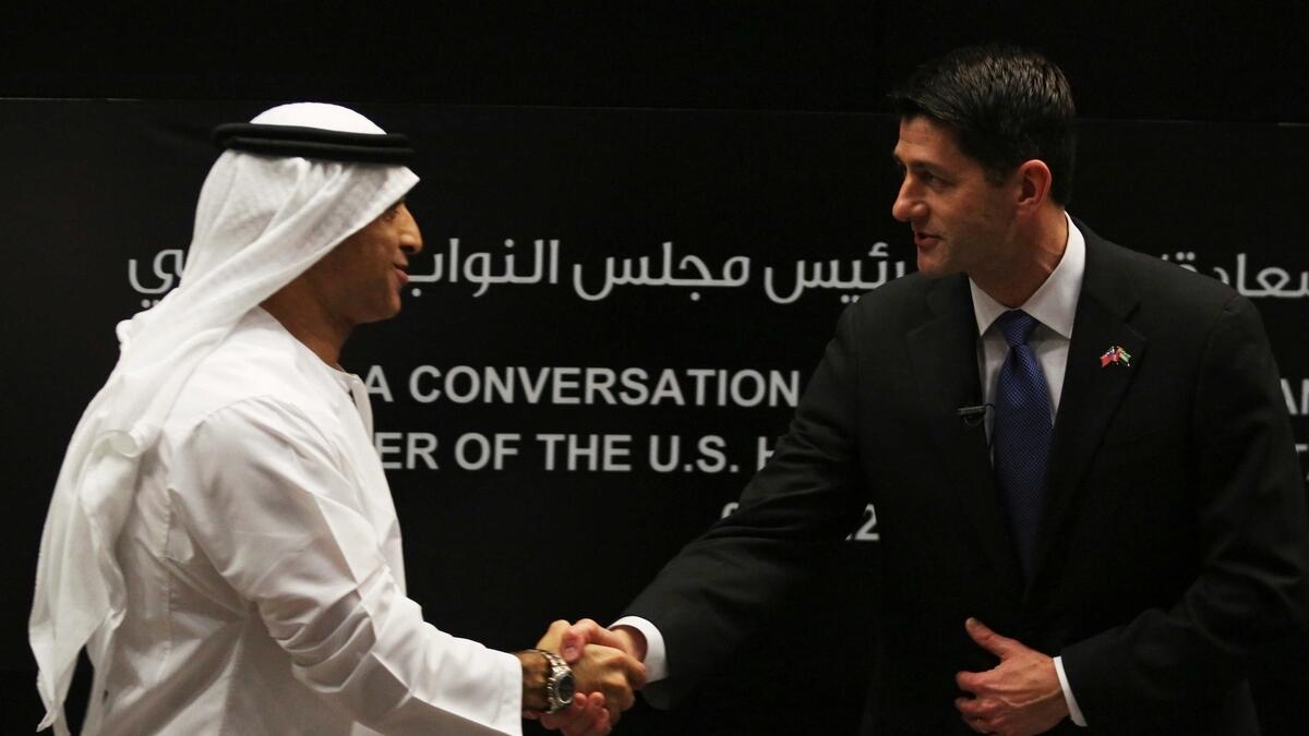 US Speaker of the House Paul Ryan (right), shakes hands with Emirati Ambassador to the US Yousef al-Otaiba (left) in Abu Dhabi.-AP 