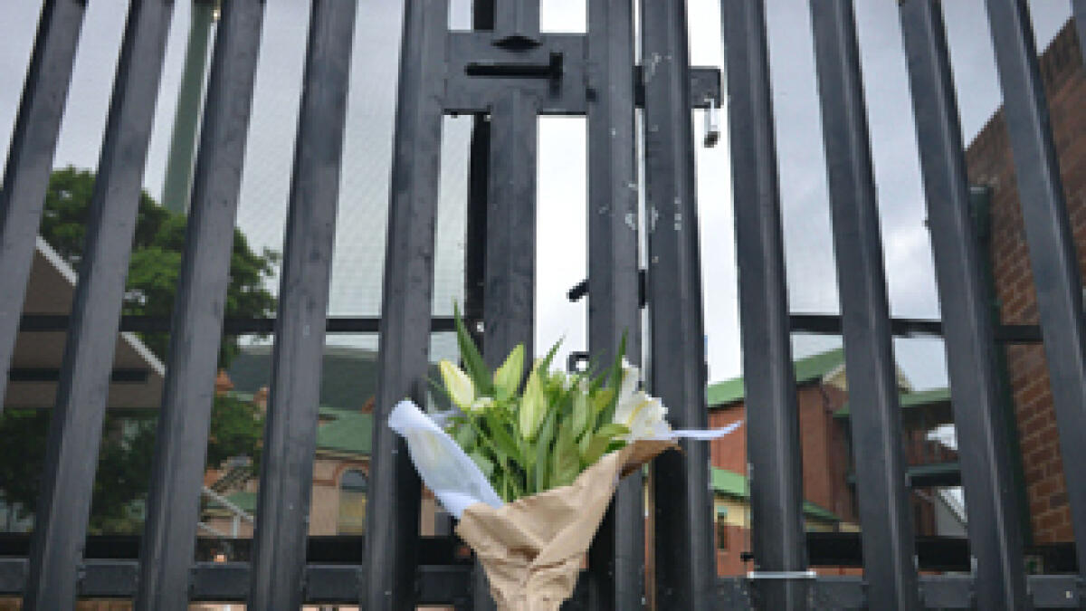 Flowers are left at the gate of Sydney Cricket Ground following the death of Australian batsman Phillips Hughes in Sydney on November 27, 2014. Hughes died on November 27 from a rare head injury after a sickening on-field blow in one of the highest-profile sporting fatalities since the death of Formula One great Ayrton Senna.   AFP PHOTO / Peter PARKS