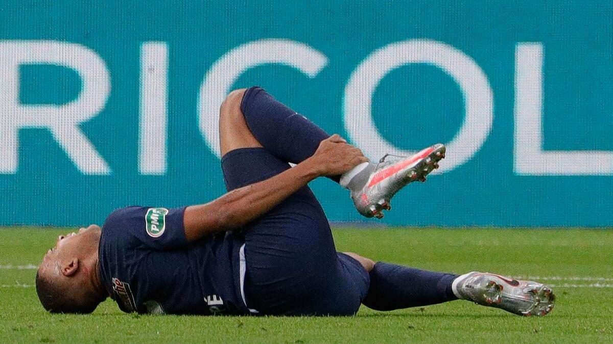 Paris Saint-Germain's Kylian Mbappe reacts after suffering an injury during the French Cup final against Saint-Etienne. (AFP)