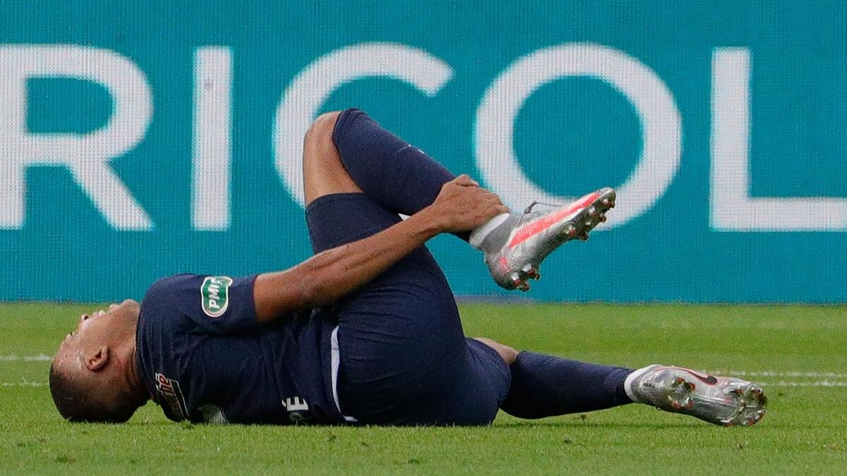 Paris Saint-Germain's Kylian Mbappe reacts after suffering an injury during the French Cup final against Saint-Etienne. (AFP)