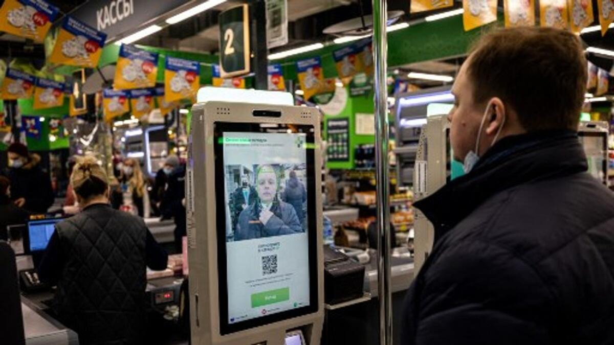 An man demonstrates a facial recognition payment system at a  self-checkout machine in a supermarket in Moscow. Photo: AFP