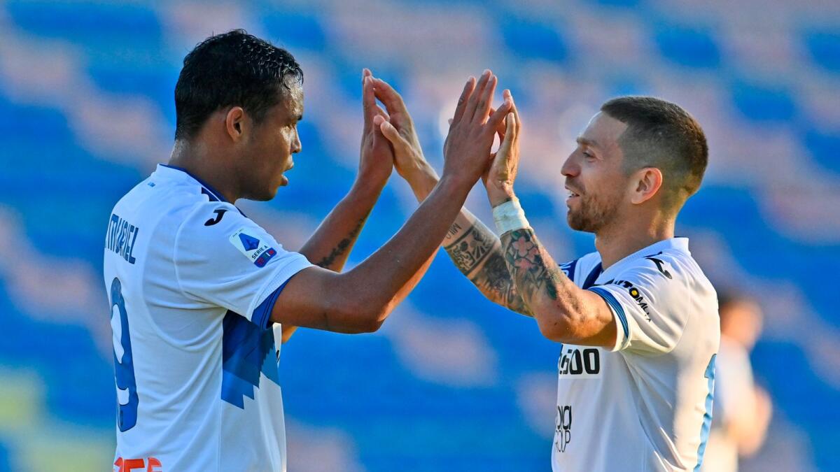 Atalanta's Muriel celebrates with teammate Papu Gomez after scoring during a Serie A match against Crotone.— AP