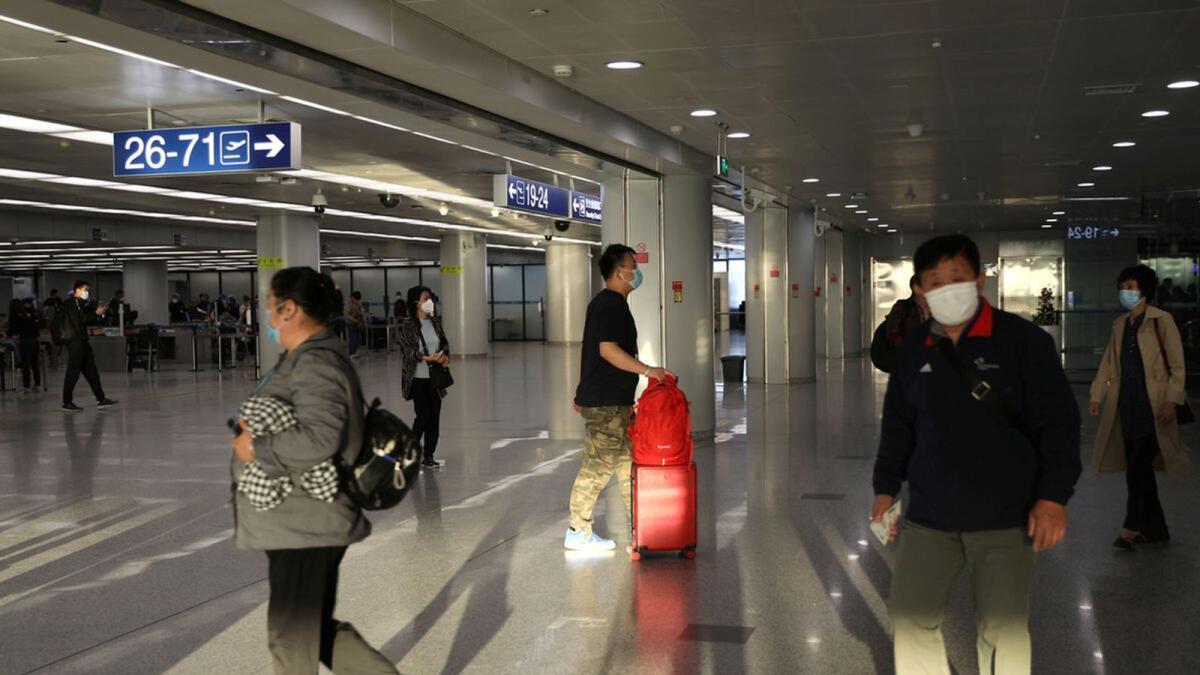 Travellers walk at the Beijing Capital International Airport in Beijing, China May 9, 2021. Photo: Reuters