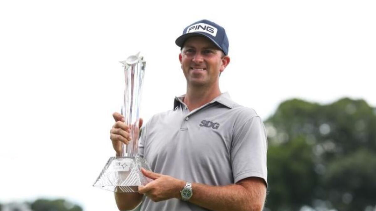 Michael Thompson celebrates his victory with the 3M Open trophy after the final round of the 3M Open golf tournament. (Reuters)