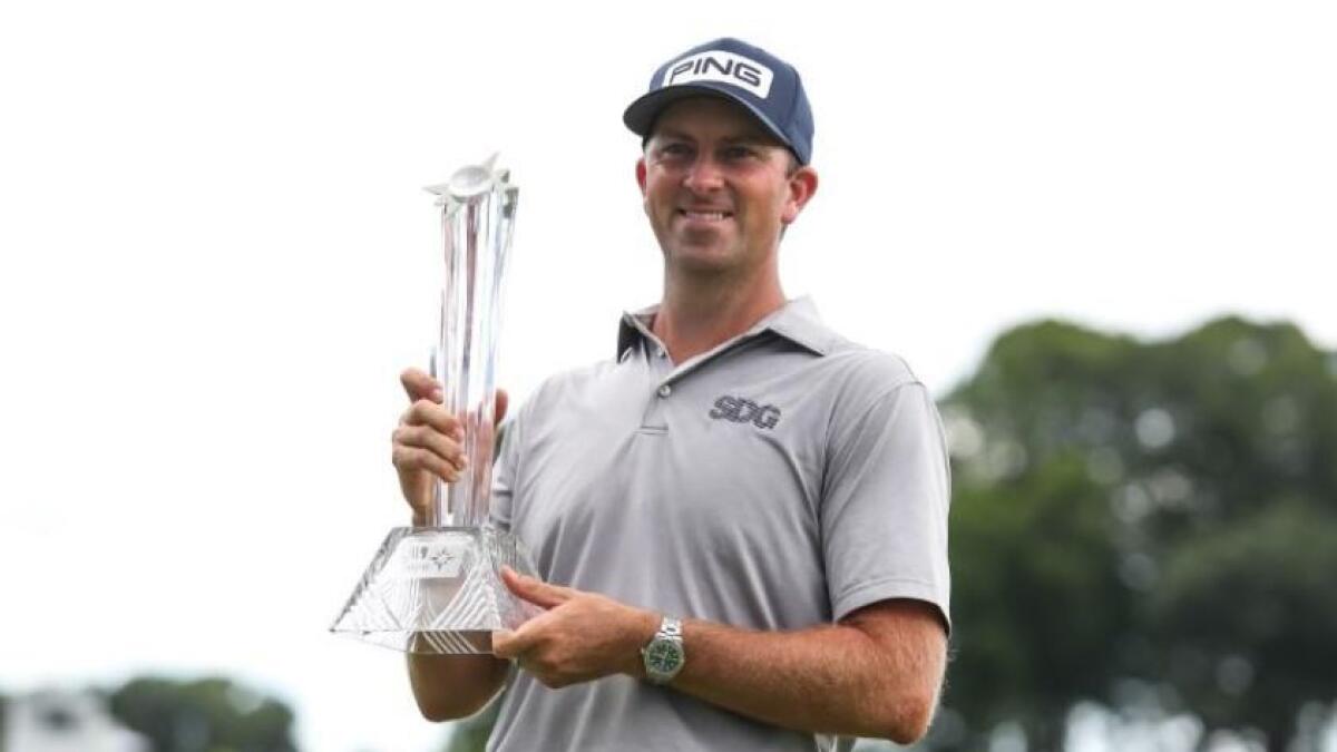 Michael Thompson celebrates his victory with the 3M Open trophy after the final round of the 3M Open golf tournament. (Reuters)