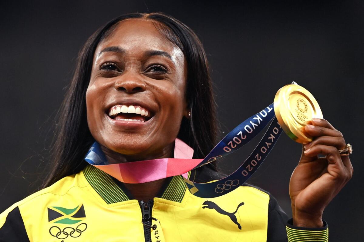 Gold medallist Elaine Thompson-Herah of Jamaica celebrates during the medal ceremony for the women's 200m event at the Tokyo Olympic Games. — AFP