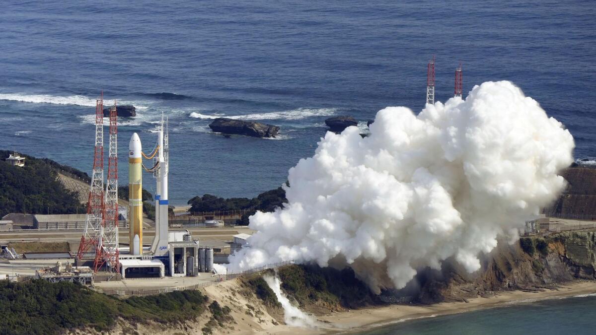 An H3 rocket sits on the launch pad next to billowing white smoke at Tanegashima Space Center in Kagoshima, southern Japan, on Friday. — AP