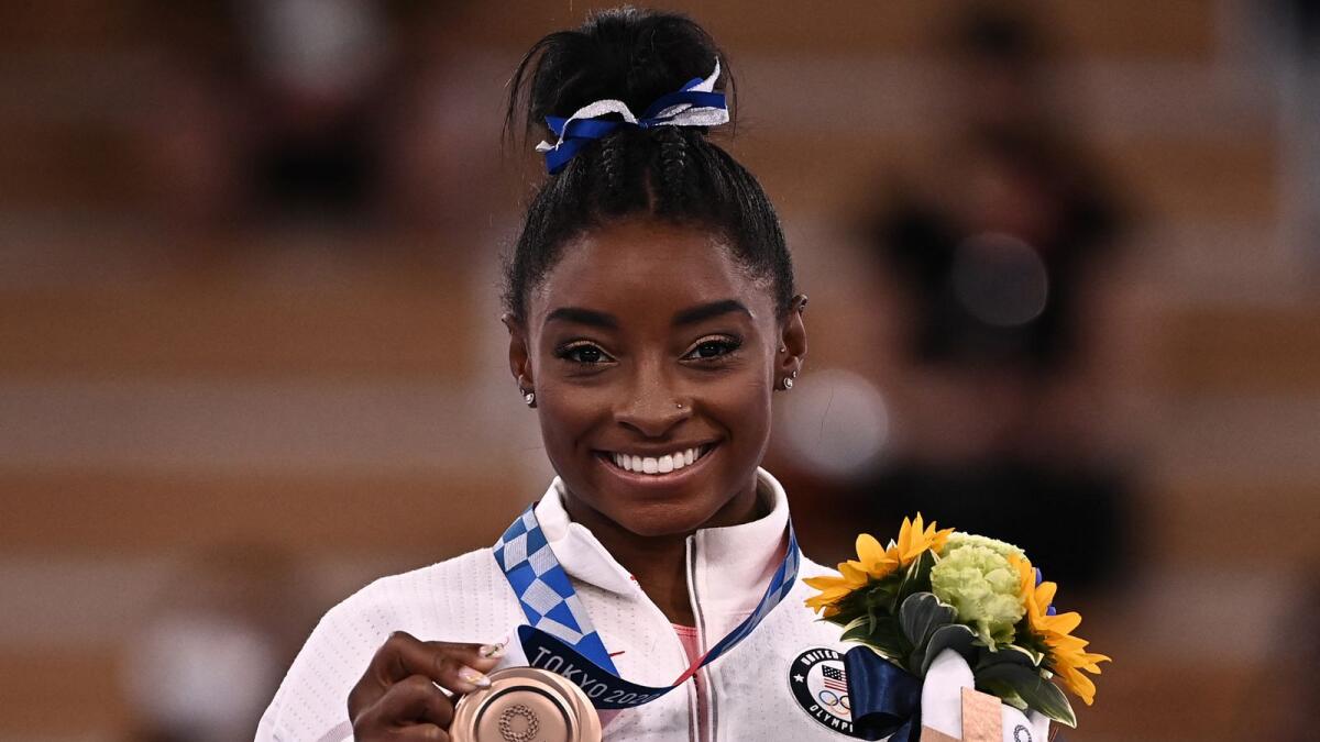 Simone Biles poses with her bronze medal. (AFP)
