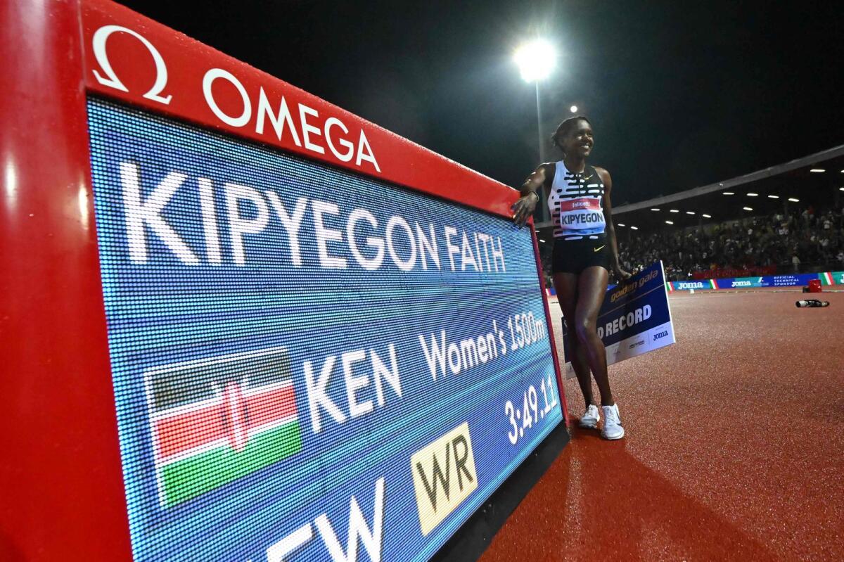 Kenya's Faith Kipyegon poses after winning the Women's 1500m event, setting a new world record of 3:49.11, - AFP