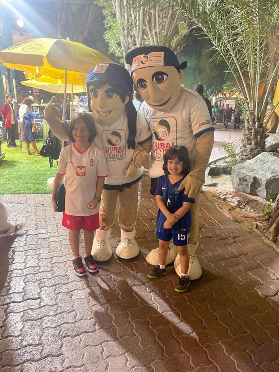 Samih (left), and his brother Ryan Ghandour pose for pictures with Dubai Duty-Free Tennis Championship mascots, Ace and Annette. — Photo by Leslie Wilson Jr
