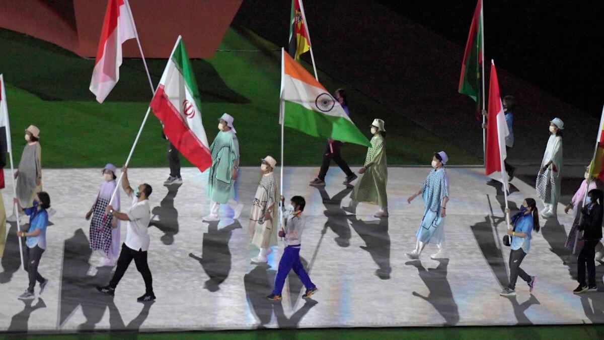 Gold medallist Neeraj Chopra holds the Indian flag at the Olympics Stadium during the closing ceremony of the Summer Olympics 2020, in Tokyo. — PTI