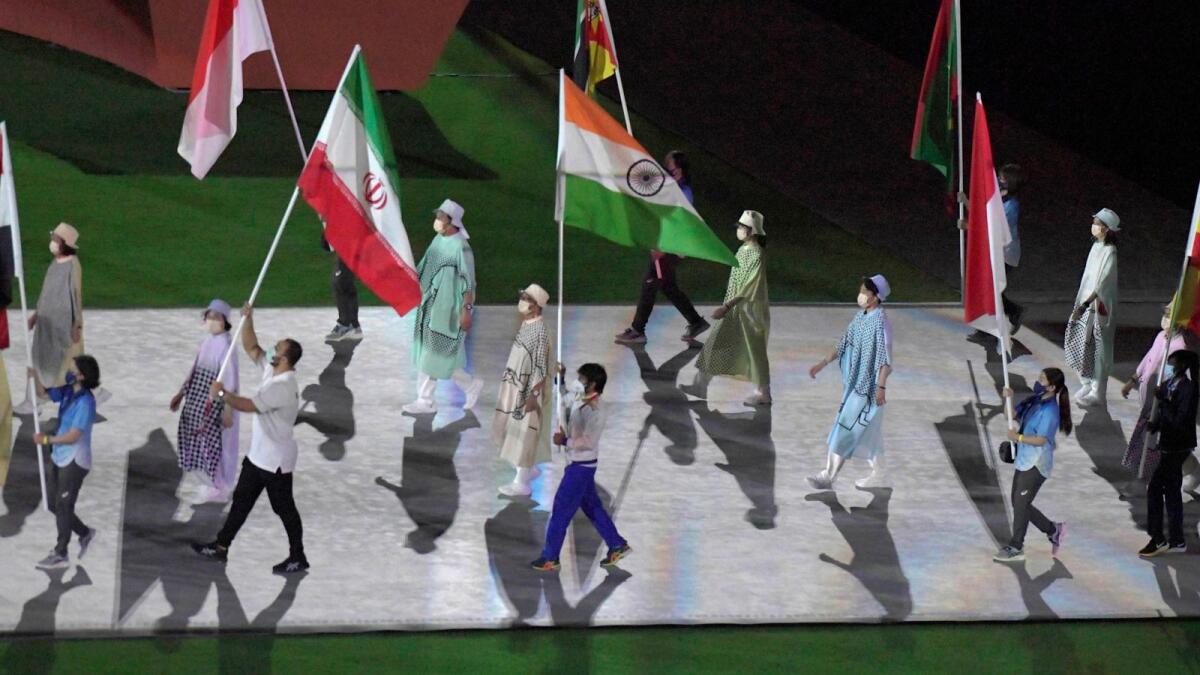 Gold medalist Neeraj Chopra holds the Indian flag at the Olympics Stadium during the closing ceremony of the Summer Olympics 2020. — PTI