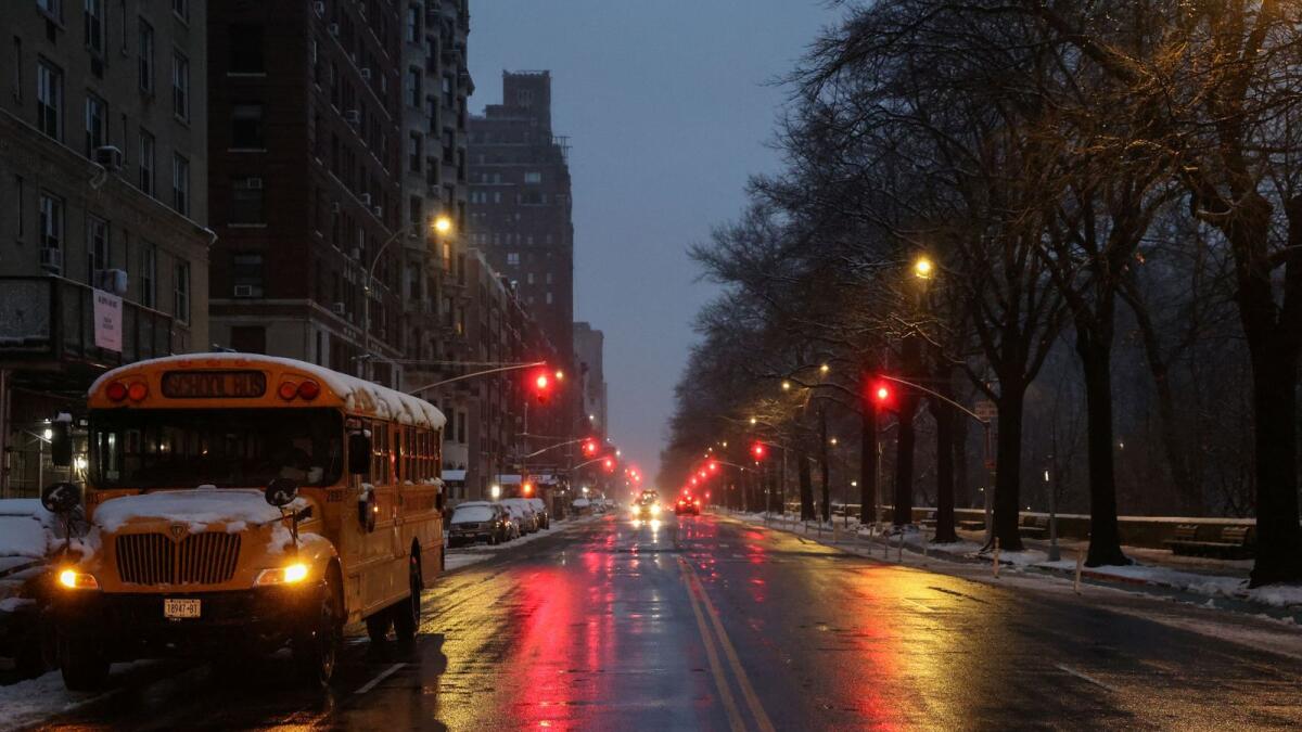 A snow covered school bus is parked near Central Park during a winter storm in New York City. — Reuters file