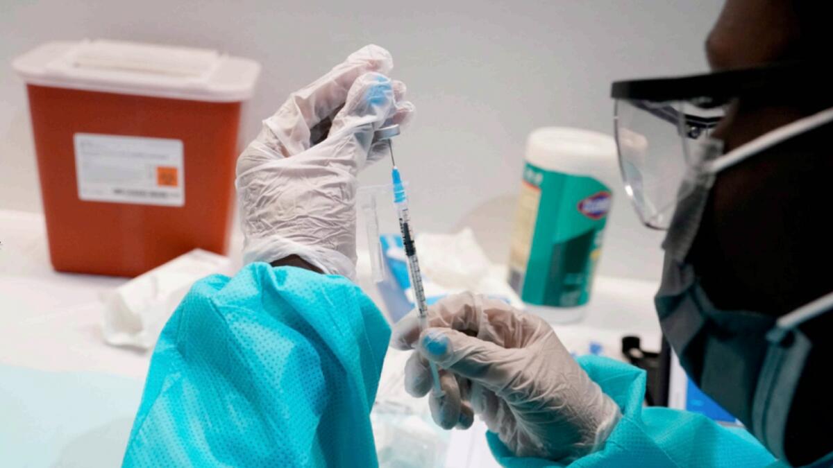 A healthcare worker fills syringe with Pfizer vaccine in New York. — AP file