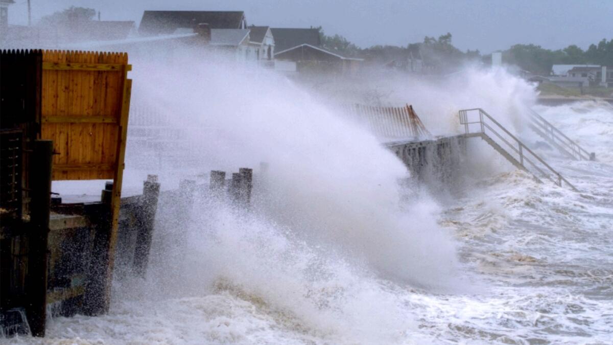 Waves pound the seawall in Montauk as Tropical Storm Henri affects the Atlantic coast. — AP