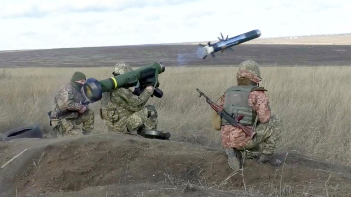 An Ukrainian soldier uses a launcher with US Javelin missiles during military exercises in Donetsk region, Ukraine. — AP