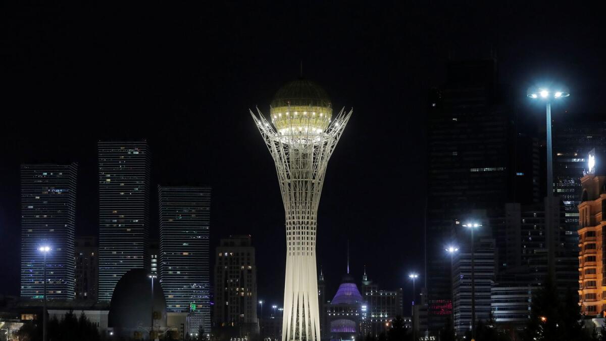 A combination photo shows the monument Baiterek before (top) and during Earth Hour in Nur-Sultan, Kazakhsta.
