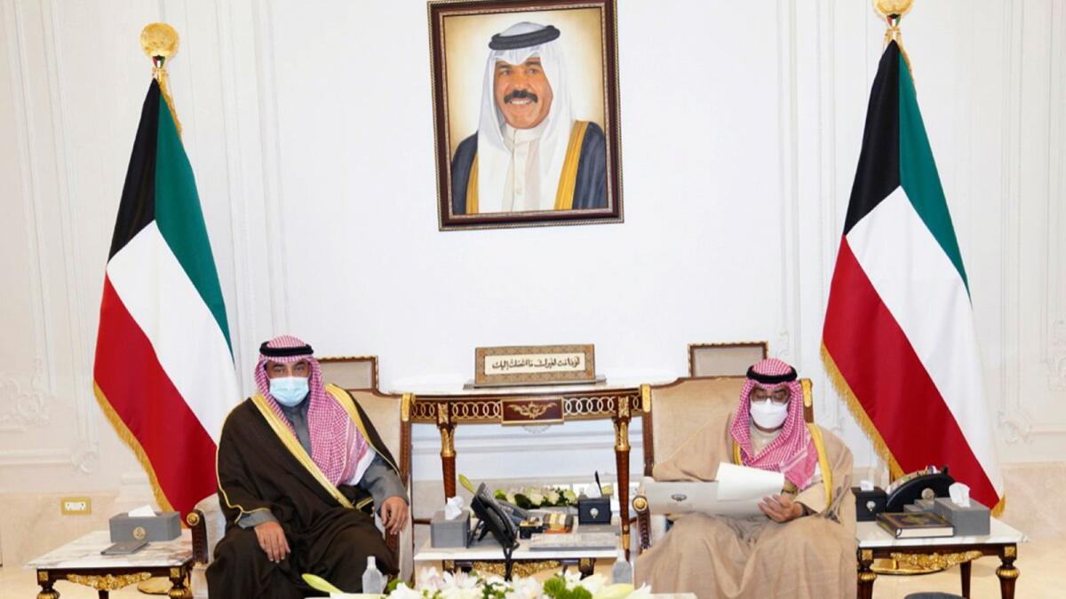 Emir of Kuwait, Sheikh Nawaf Al Ahmad Al Sabah, receives Prime Minister Sheikh Sabah Al Khaled Al Hamad Al Sabah, in Kuwait. The emir announced the formation of a new Cabinet on Tuesday. – AP