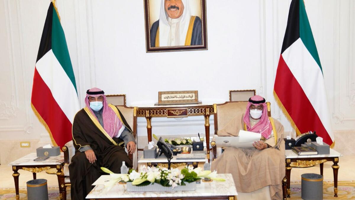 Emir of Kuwait, Sheikh Nawaf Al Ahmad Al Sabah, receives Prime Minister Sheikh Sabah Al Khaled Al Hamad Al Sabah, in Kuwait. The emir announced the formation of a new Cabinet on Tuesday. – AP